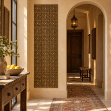 Rotating Loop Knot Celtic knot tiles in hand-embossed brass, as a tall vertical panel beside an arched doorway in a hallway