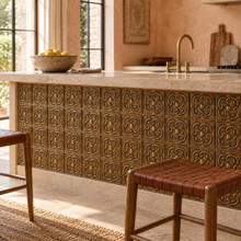 Rotating Loop Knot Celtic knot tiles in hand-embossed brass, set into the front panel of a stone-topped kitchen island