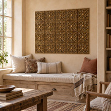 Rotating Loop Knot Celtic knot tiles in hand-embossed brass, as a wall panel above a cushioned window seat in a reading nook