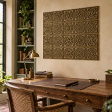 Four Loop Circle Knot Celtic knot tiles in hand-embossed brass, as a wall panel above a wooden writing desk in a study