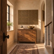 Diamond Lattice Knot Celtic knot tiles in hand-embossed brass, as a wall panel above a chest of drawers in an entrance hall