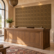 Four Heart Knot Celtic knot tiles in hand-embossed brass, as a large wall panel behind a wooden reception counter