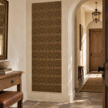 Sun Star Knot Celtic knot tiles in hand-embossed brass, as a tall vertical panel beside an arched doorway in a hallway