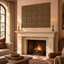 Braided Triangle Knot in hand-embossed brass, as a feature panel above a stone fireplace mantel in a living room