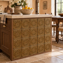 Hexagon Ring Knot Celtic knot tiles in hand-embossed brass, set into the end panel of a stone-topped kitchen island
