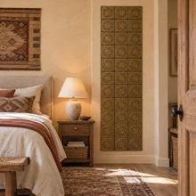 Hexagon Ring Knot Celtic knot tiles in hand-embossed brass, as a tall vertical panel beside a bed in a bedroom