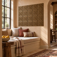 Dense Circle Knot Celtic knot tiles in hand-embossed brass, as a wall panel above a cushioned window seat in a reading nook