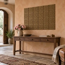 Lattice Loop Knot Celtic knot tiles in hand-embossed brass, as a wall panel above a console table in an entrance hall