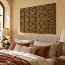 Butterfly Knot Celtic knot tiles in hand-embossed brass, as a feature panel above the headboard in a bedroom