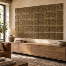 Fine Ring Knot Celtic knot tiles in hand-embossed brass, as a large wall panel above a low media console in a living room