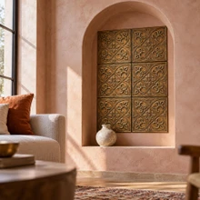 Fleur-de-Lis hand-embossed solid brass tiles in aged bronze lining an arched wall niche