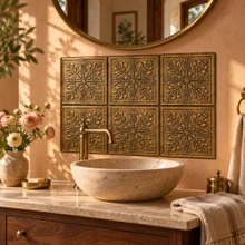 Hand-embossed solid brass thistle tiles in aged bronze as a bathroom vanity backsplash above a basin