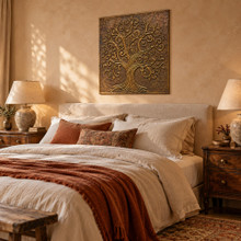 One hand-embossed solid brass swirl Tree of Life panel in aged bronze hung above the headboard in a bedroom