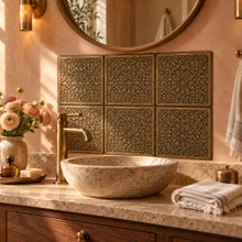 Hand-embossed solid brass Moorish star tiles in aged bronze as a bathroom vanity backsplash above a basin