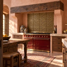Hand-embossed solid brass Marrakesh lattice tiles in aged bronze installed as a kitchen backsplash behind a range
