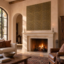 Marrakesh Lattice, large 12 inch hand-embossed solid brass tiles in aged bronze: feature panel above a living room fireplace