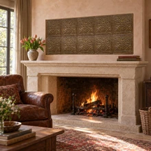 Hand-embossed solid brass Oak and Acorn tiles in aged bronze: above a fireplace mantel