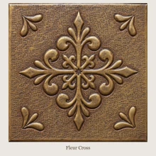 Fleur Cross: one hand-embossed solid brass tile in aged bronze, 6 mm deep with a raised rim, shown as it will be made