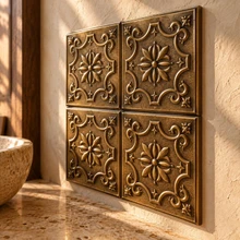 Cartouche, hand-embossed solid brass in aged bronze: close-up of the 6 mm tile edges and raised rims