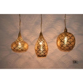 Moroccan brass pendant light hanging over a kitchen island

