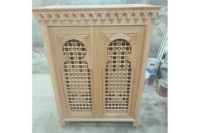 Carved arched cabinet in hand-cut solid wood