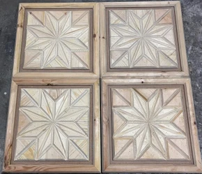 Set of four eight-point star wood marquetry ceiling tiles arranged in a grid