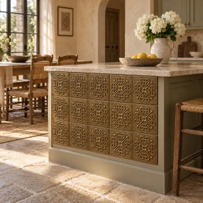 Loop Cross Knot Celtic knot tiles in hand-embossed brass, set into the end panel of a stone-topped kitchen island