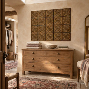 Quatrefoil Circle Knot in hand-embossed brass, as a wall panel above a wooden chest of drawers in a dressing room