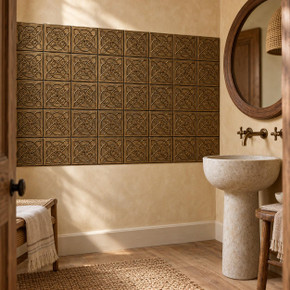 Dense Circle Knot Celtic knot tiles in hand-embossed brass, as a large wall panel beside a pedestal sink in a bathroom