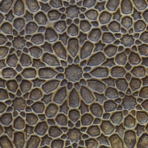 Close-up of the hand-embossed Moorish star relief showing the hand-punched ground and darker patina in the recesses