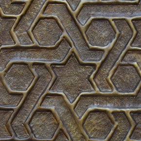 Close-up of the hand-embossed Marrakesh lattice relief showing the hand-punched ground and darker patina in the recesses