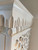 Carved bathroom vanity cabinet — carved crown molding above the lattice panel