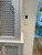 Carved bathroom vanity cabinet — installed view showing the lattice pattern