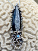 Fossilized Orthoceras Creature Pendant with blue topaz.