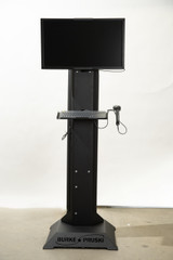 Rolling mobile workstation with integrated computer mount for on-floor monitoring, task organization, and improved job efficiency in industrial environments.