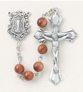 New England pewter rosary made with 6mm round genuine gold sand beads. Exclusive designed sterling silver Miraculous centerpiece and sterling silver 1-7/8”crucifix. Handmade in the USA. Presented in a deluxe velour metal gift box.