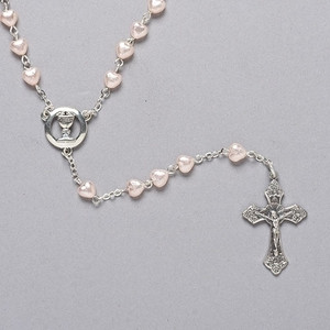 First communion 18"L Heart Rosary. Rosary is made of 6mm Pearlized Pink Heart Shaped Glass Beads. Centerpiece is a Chalice Comes in a velvet box. A wonderful keepsake for any girl making her communion to treasure forever.