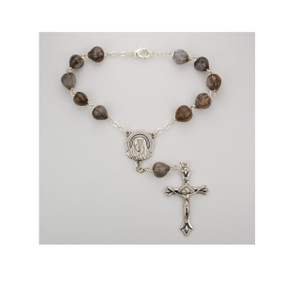 This auto rosary measures 7 1/4" long. The beads are a genuine Job's Tears with a silver ox papal crucifix and Madonna center. Comes with a clasp for easy hanging. 