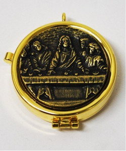 Eucharistic Teca "Last Supper" with bronze-colored relief plaque. Complete with ring to hang it on the neck. Measures 2" round x 1/2"H