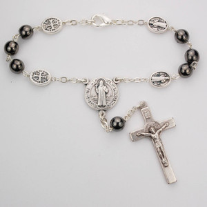 St Benedict Hematite Auto Rosary. 7MM hematite beads with silver oxidized crucifix and center. Comes on a hang tag. 