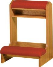 Square wooden structure with red pads for kneeling and resting one's arms.
 
