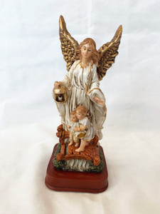 Gold and white guardian angel standing above two children on a bridge.