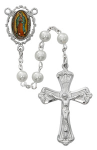 6mm Pearlized Glass Beads with Rhodium Plated Pewter Crucifix and Our Lady of Guadalupe Decal Center.  18" in Length. Deluxe Gift Box Included. Made in the USA