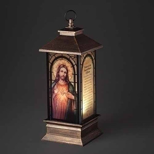 11"H LED Sacred Heart of Jesus Lantern. Lantern is made of plastic. Dimensions: 10.5"H 4"W 4"L.  Lantern is battery operated. 3AA Batteries not included. 