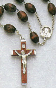 Bring together the family in devotion and prayer with this Family Wood Rosary. The oval rosary beads are strung together by a series of lightweight chains and the wooden crucifix holds a miniature image of Christ. Together with the Catholic bible and pictures of saints, the rosary is a constant fixture to show Catholic devotion. Reflect on the life of Jesus and the Blessed Mother with the simple and stunning Family Wood Rosary. Wood family rosary 30" long in black or brown