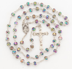 6mm Metallic multicolor vitriol helix crystal beads with sterling silver sacred heart center and exclusive design crucifix. Rhodium plated brass wires and chain. Comes with a deluxe velour gift box. Made in the USA