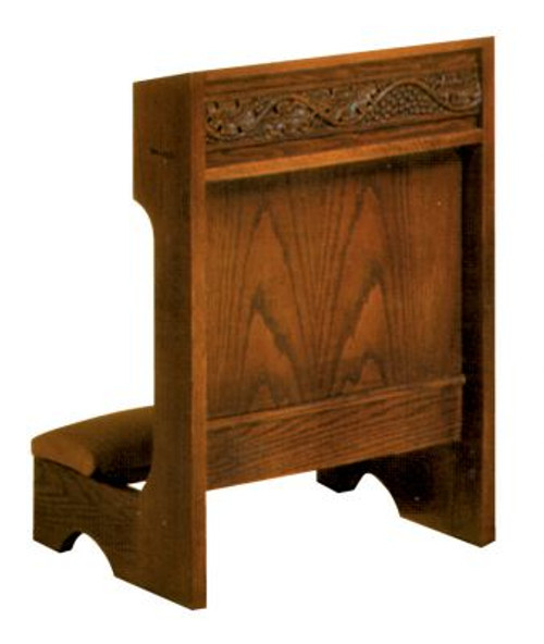 Rectangular wooden structure with a kneeling pad and decorative design carved into the front.