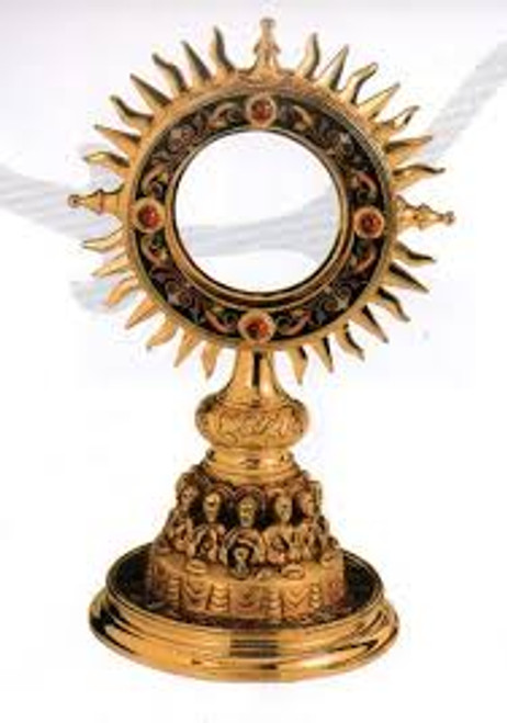 Gold ostensoria in shape of sun with detailed carvings
