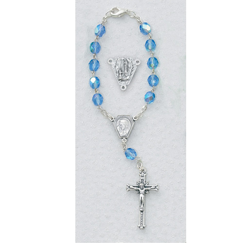 Carded Our Lady of Lourdes Blue Auto Roasary with silver ox crucifix and center.