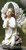 Add a beautiful style to your garden by adding this kneeling and praying angel statue. This statue features an angel kneeling by flowers, with her hands together in prayer.  Dimensions: 15.75"H x 8"W x 5.5"D. Statue is made of a resin and stone mix